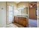Bathroom vanity with granite counters and walk out to patio and backyard at 18131 W Palo Verde Ct, Litchfield Park, AZ 85340