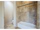 Neutral bathroom showcasing bathtub with beige tile surround and dark shower rod at 18131 W Palo Verde Ct, Litchfield Park, AZ 85340