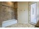Bathroom features bathtub and shower with access to outdoor patio at 18131 W Palo Verde Ct, Litchfield Park, AZ 85340