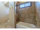Tiled bathroom with a shower and tub combination offering a relaxing and luxurious experience at 18131 W Palo Verde Ct, Litchfield Park, AZ 85340