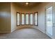 Bright bedroom showcases a curved wall of windows with plantation shutters and a glass door at 18131 W Palo Verde Ct, Litchfield Park, AZ 85340