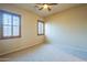 This bedroom features wood shutter blinds, neutral walls and carpet, and a ceiling fan at 18131 W Palo Verde Ct, Litchfield Park, AZ 85340