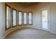 Sun-drenched bedroom with a curved wall featuring several windows with adjustable plantation shutters at 18131 W Palo Verde Ct, Litchfield Park, AZ 85340