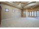 Spacious bedroom features a tray ceiling, tan carpet and walls, and an abundance of natural light at 18131 W Palo Verde Ct, Litchfield Park, AZ 85340