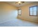 Bedroom features wood shutter blinds, neutral walls and carpet, and a ceiling fan at 18131 W Palo Verde Ct, Litchfield Park, AZ 85340