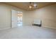 Bright, carpeted bedroom features a bench and door to another room providing an inviting atmosphere at 18131 W Palo Verde Ct, Litchfield Park, AZ 85340