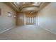Large bonus room with carpet and bay windows for natural light, creating a comfortable and inviting atmosphere at 18131 W Palo Verde Ct, Litchfield Park, AZ 85340