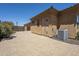 Exterior shot of a stucco building with a tan tile roof and paved driveway at 18131 W Palo Verde Ct, Litchfield Park, AZ 85340