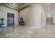Entry foyer features travertine floors and entry door at 18131 W Palo Verde Ct, Litchfield Park, AZ 85340