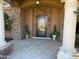 Elegant home entrance with a decorative iron door, stone accents, and inviting curb appeal at 18131 W Palo Verde Ct, Litchfield Park, AZ 85340