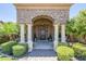 Grand front entrance featuring stone accents, columns, and lion statues that create a stately and inviting ambiance at 18131 W Palo Verde Ct, Litchfield Park, AZ 85340