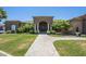 Inviting home exterior featuring manicured landscaping, a stone facade, and a welcoming walkway to the front entrance at 18131 W Palo Verde Ct, Litchfield Park, AZ 85340