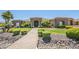 Beautiful desert home showcasing stone accents, manicured landscaping, and a brick walkway leading to the front entrance at 18131 W Palo Verde Ct, Litchfield Park, AZ 85340