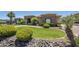Expansive front yard features lush green grass and well-maintained landscaping that adds curb appeal to the desert home at 18131 W Palo Verde Ct, Litchfield Park, AZ 85340