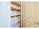 Hallway closet with lots of shelving offering room for plenty of storage at 18131 W Palo Verde Ct, Litchfield Park, AZ 85340