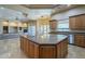Gourmet kitchen features an island with granite countertops at 18131 W Palo Verde Ct, Litchfield Park, AZ 85340