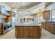 Gourmet kitchen with stainless steel appliances opens to a dining area at 18131 W Palo Verde Ct, Litchfield Park, AZ 85340