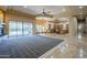 Expansive living room with fireplace and sliding doors, seamlessly connecting to a modern kitchen and breakfast nook at 18131 W Palo Verde Ct, Litchfield Park, AZ 85340