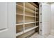 Spacious walk-in pantry with white shelving and ample storage space at 18131 W Palo Verde Ct, Litchfield Park, AZ 85340