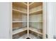 Walk-in pantry with adjustable shelving for ample storage at 18131 W Palo Verde Ct, Litchfield Park, AZ 85340