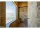 Contemporary tiled shower with glass window and neutral decor at 18131 W Palo Verde Ct, Litchfield Park, AZ 85340