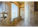 Contemporary tiled shower with glass window and built-in bench at 18131 W Palo Verde Ct, Litchfield Park, AZ 85340