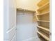 Walk-in closet with ample shelving and storage, providing organization for clothing and accessories at 18131 W Palo Verde Ct, Litchfield Park, AZ 85340