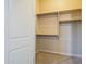 This walk-in closet has a shelf and rods for organizing at 18131 W Palo Verde Ct, Litchfield Park, AZ 85340