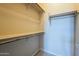 This walk-in closet has a shelf and rods for organizing at 18131 W Palo Verde Ct, Litchfield Park, AZ 85340