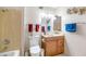 Well-lit bathroom with a marble sink, and a shower/tub combo with neutral fixtures at 18655 N Palomar Dr, Sun City West, AZ 85375