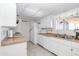 Efficient kitchen with white appliances, ample cabinet space, and neutral countertops at 18655 N Palomar Dr, Sun City West, AZ 85375