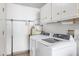 Functional laundry room equipped with modern washer, dryer, and storage options at 18655 N Palomar Dr, Sun City West, AZ 85375