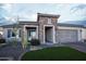 Charming exterior with stone accents, turf yard and desert landscaping at 19139 N 260Th Ave, Buckeye, AZ 85396