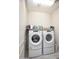 Bright laundry room with stacked washer and dryer at 19139 N 260Th Ave, Buckeye, AZ 85396