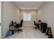 Bright office space featuring a window with plantation shutters and space for two workstations at 19139 N 260Th Ave, Buckeye, AZ 85396