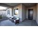 Relax on the home's covered front porch with comfy cushioned seating at 19139 N 260Th Ave, Buckeye, AZ 85396