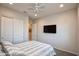 Relaxing bedroom with a ceiling fan, soft carpet, a spacious closet and a flat screen tv at 19139 N 260Th Ave, Buckeye, AZ 85396