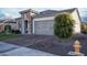 Exterior of home with a stone facade, desert landscaping, and a brick driveway at 19139 N 260Th Ave, Buckeye, AZ 85396