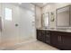 Modern bathroom with walk-in shower, dual vanities, and tile flooring at 19920 W Monterosa St, Litchfield Park, AZ 85340