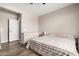 A well-lit, neutral bedroom featuring hardwood-style flooring and ample closet space at 19920 W Monterosa St, Litchfield Park, AZ 85340