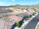 Aerial view of homes in a desert community with mountain views; new construction underway nearby at 20373 W Calle Encorvada --, Buckeye, AZ 85396