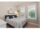 Cozy bedroom features neutral walls, hardwood floors, and bright, shuttered windows at 20477 W Ridge Rd, Buckeye, AZ 85396