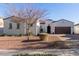 Charming single-story home with a well-maintained front yard, brick-paved driveway, and a two-car garage at 20477 W Ridge Rd, Buckeye, AZ 85396