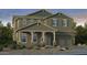 Charming two-story home featuring a covered front porch, two-car garage and desert landscaping at 20756 E Arroyo Verde Dr, Queen Creek, AZ 85142