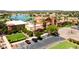 Stunning aerial view of community center, pool, lake, and lush landscaping at 20934 N Sweet Dreams Dr, Maricopa, AZ 85138
