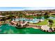 Picturesque aerial view of community pool with landscaped surroundings and lake at 20934 N Sweet Dreams Dr, Maricopa, AZ 85138