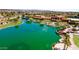 Picturesque aerial view of lake featuring lush landscaping and mature palm trees at 20934 N Sweet Dreams Dr, Maricopa, AZ 85138