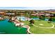 Picturesque aerial view of community pool with lush landscaping and lake at 20934 N Sweet Dreams Dr, Maricopa, AZ 85138