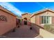 Charming front courtyard with brick pavers, potted plants, and an inviting entrance at 20934 N Sweet Dreams Dr, Maricopa, AZ 85138