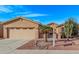 Charming single-story home features a low-maintenance desert landscape and a two-car garage at 20934 N Sweet Dreams Dr, Maricopa, AZ 85138